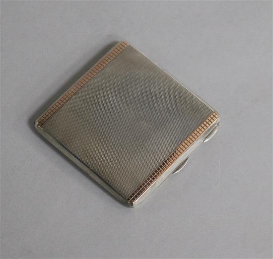 A 1960s engine turned silver and gold overlaid compact, 70mm.